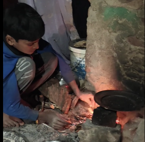 Dani cooking his meal on a steel plate